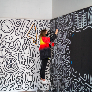 Artist painting a mural