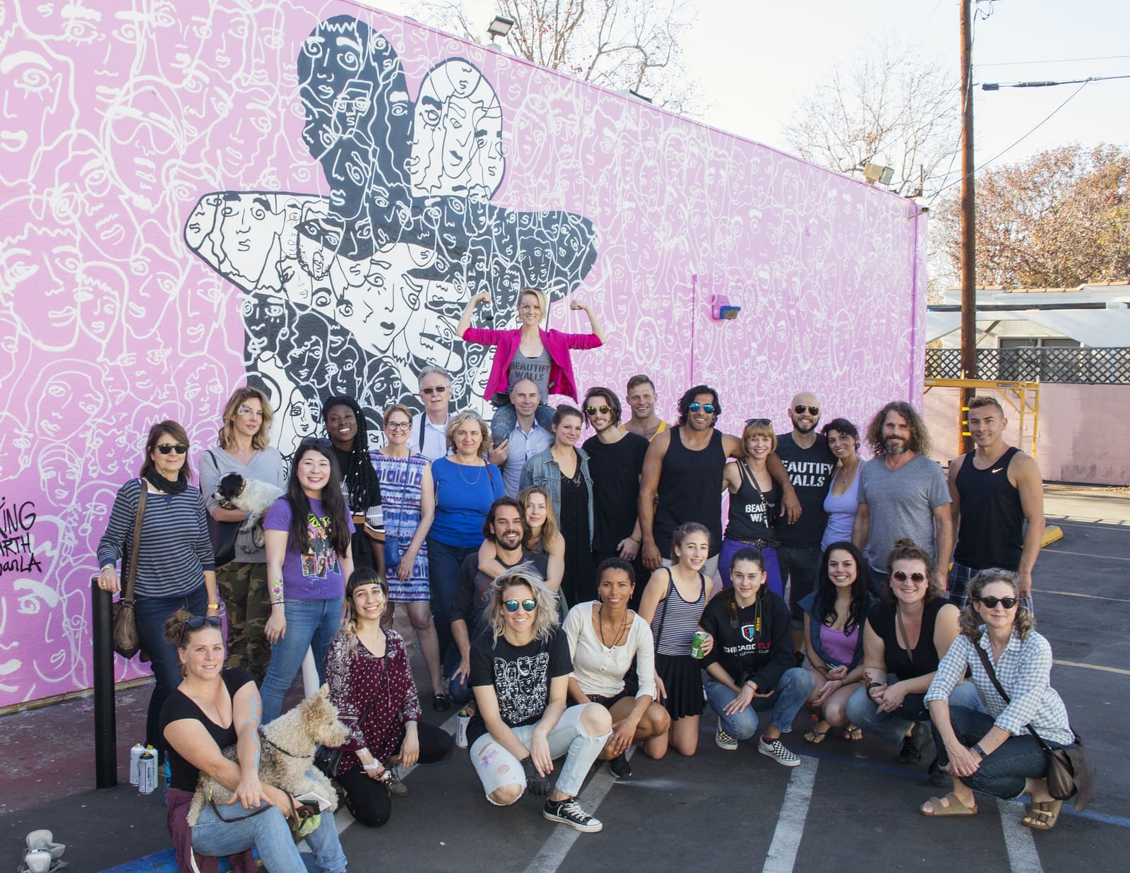 Beautify Earth volunteers in front of a mural